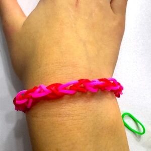 This is a red and pink bracelet size small